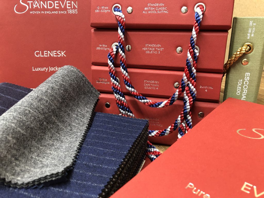 Bunches of Standeven's Autumn/ Winter cloths are displayed in red books with gold embossed labels.